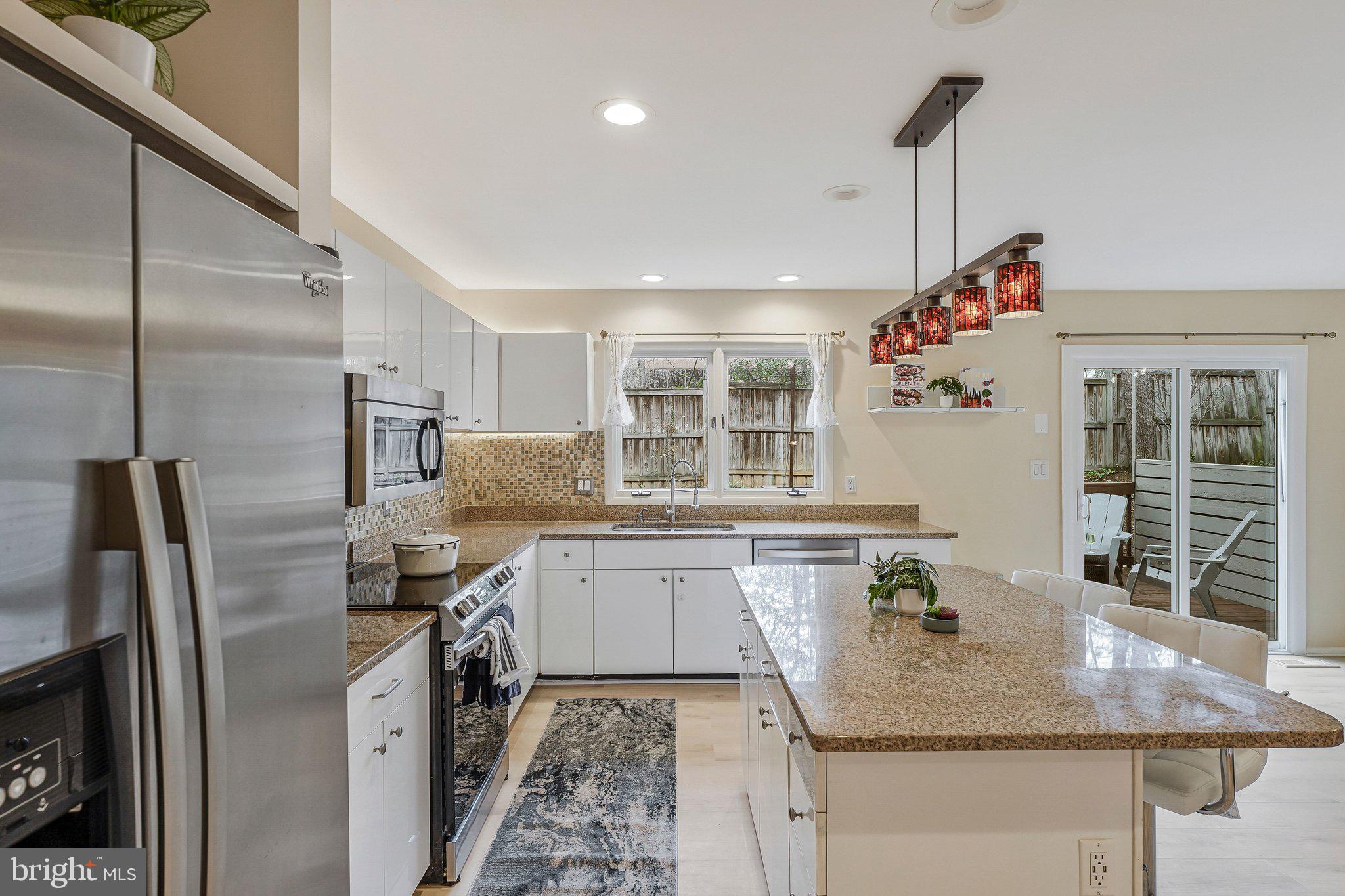 11123 Lakespray Way Reston, VA 20191 - Photo 12 of 47 a kitchen with stainless steel appliances granite countertop a sink refrigerator and microwave