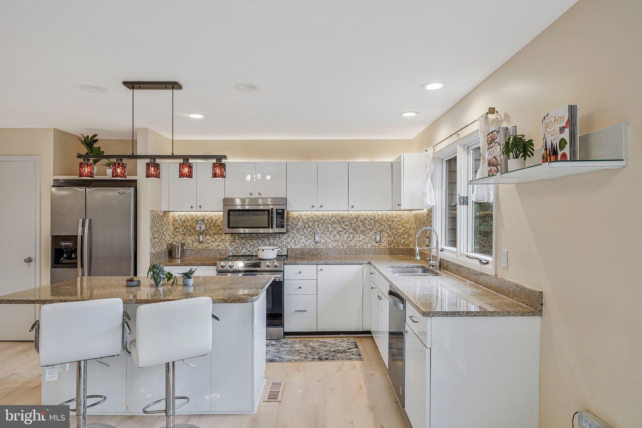 11123 Lakespray Way Reston, VA 20191 - Photo 13 of 47 a kitchen with a sink stove and cabinets