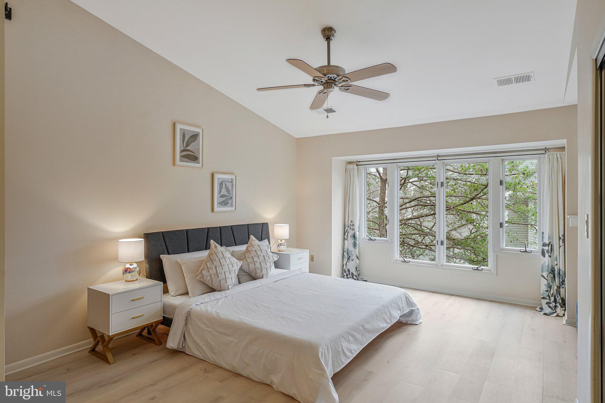 11123 Lakespray Way Reston, VA 20191 - Photo 24 of 47 a bedroom with a bed and glass window