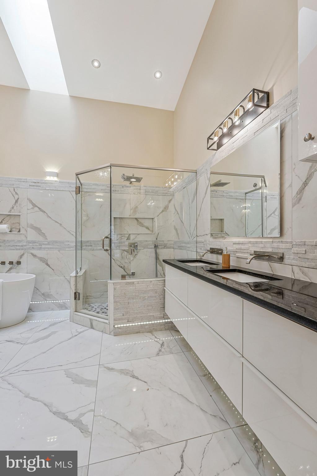 11123 Lakespray Way Reston, VA 20191 - Photo 28 of 47 a bathroom with a large mirror and a shower