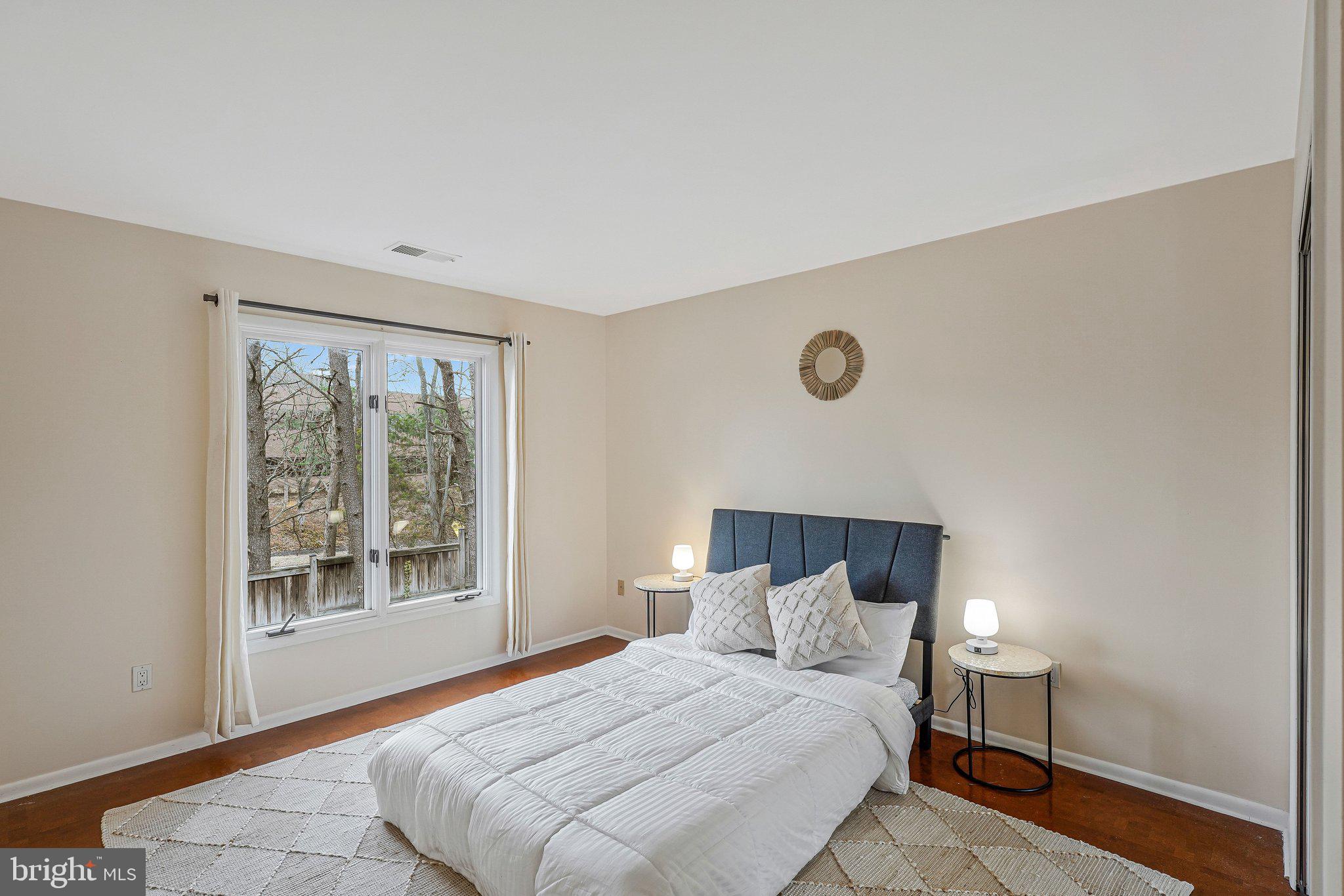 11123 Lakespray Way Reston, VA 20191 - Photo 30 of 47 a bedroom with a large bed and a window