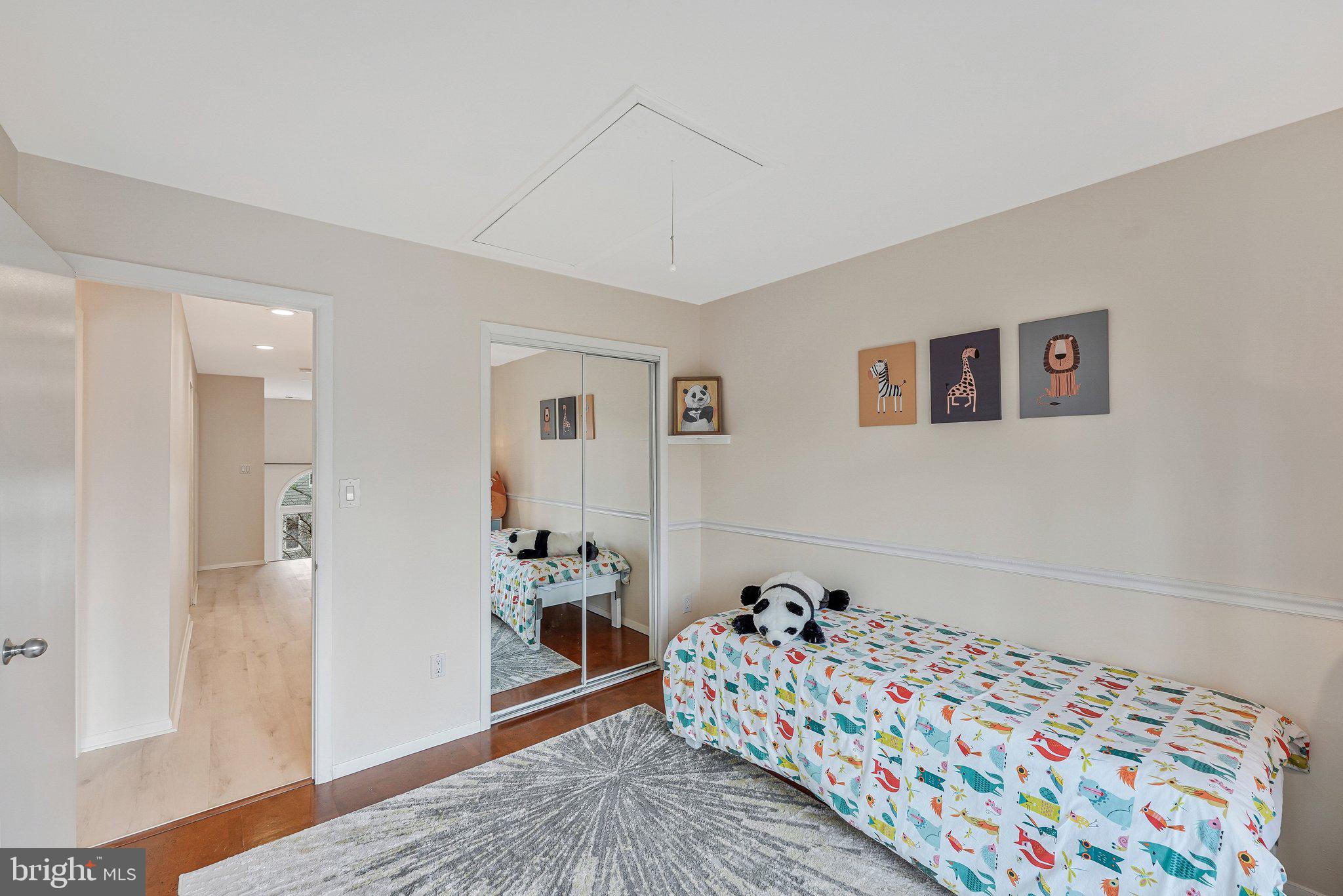 11123 Lakespray Way Reston, VA 20191 - Photo 32 of 47 a bedroom with a bed and wooden floor