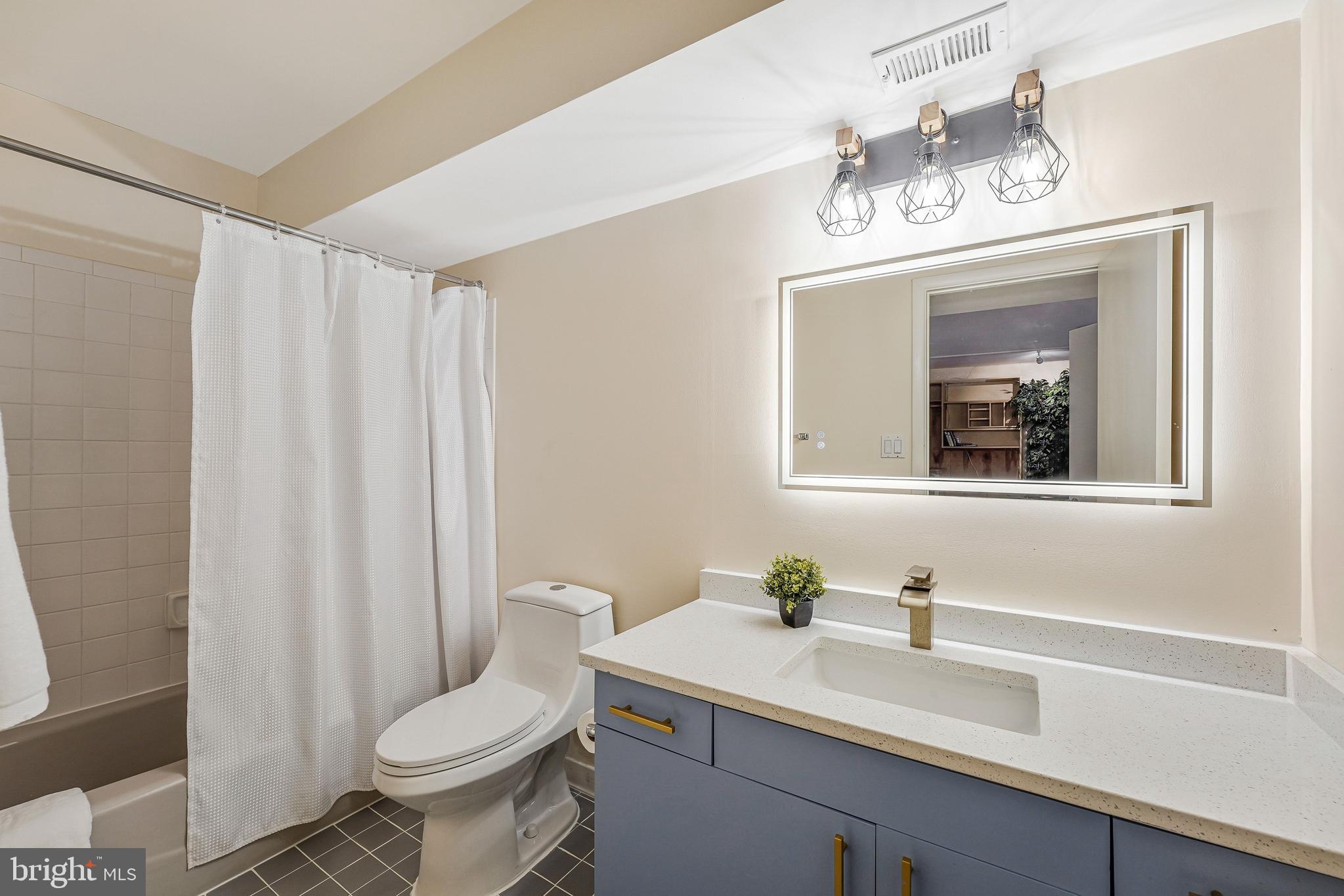 11123 Lakespray Way Reston, VA 20191 - Photo 40 of 47 a bathroom with a sink vanity granite toilet and a mirror