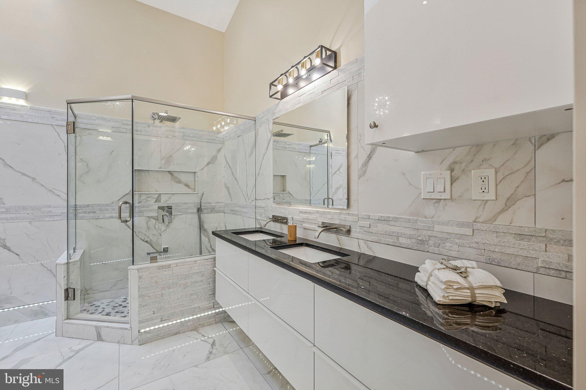 11123 Lakespray Way Reston, VA 20191 - Photo 5 of 47 a bathroom with a granite countertop sink a mirror and shower