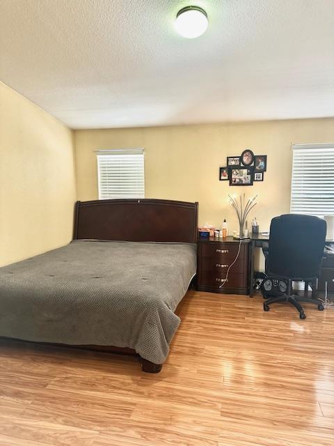 555 Umbarger Road, Unit 108 San Jose, CA 95111 - Photo 12 of 15 a bedroom with a bed and wooden floor