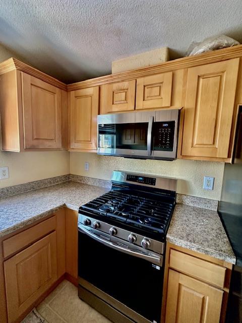 555 Umbarger Road, Unit 108 San Jose, CA 95111 - Photo 4 of 15 a kitchen with stainless steel appliances granite countertop white cabinets stove top oven and microwave