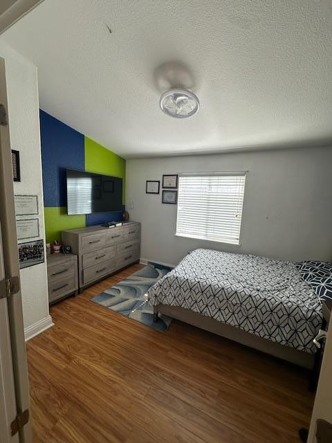 555 Umbarger Road, Unit 108 San Jose, CA 95111 - Photo 7 of 15 a bedroom with a bed and flat tv screen on the dresser