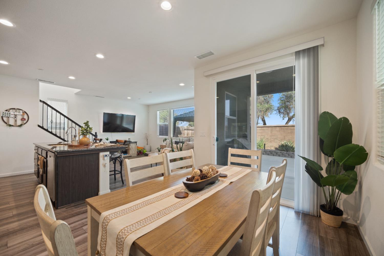 855 Wishon Avenue Madera, CA 93636 - Photo 11 of 29 a view of a dining room with furniture a potted plant and wooden floor