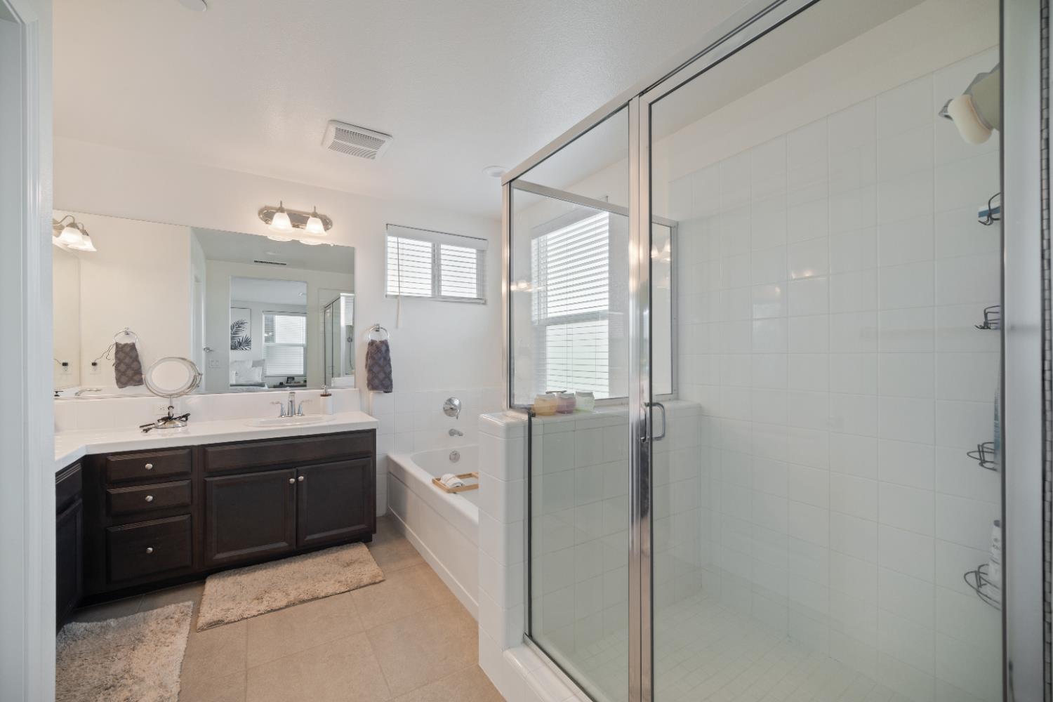 855 Wishon Avenue Madera, CA 93636 - Photo 15 of 29 a spacious bathroom with a double vanity sink a mirror and a shower