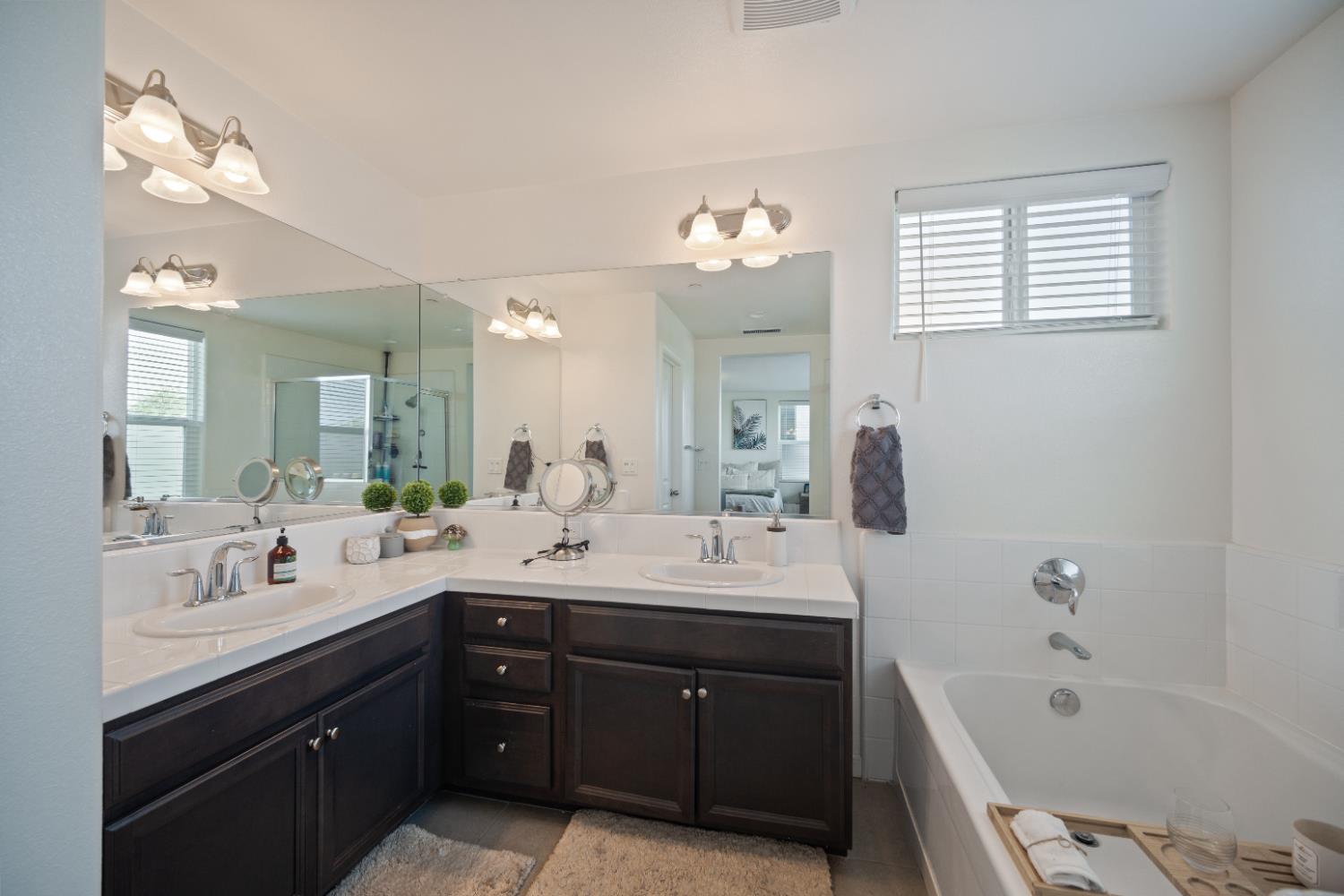 855 Wishon Avenue Madera, CA 93636 - Photo 16 of 29 a spacious bathroom with a tub double sink and mirror