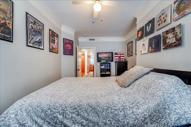 a bedroom with a large bed and a chandelier