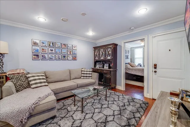 a living room with furniture and a wooden floor