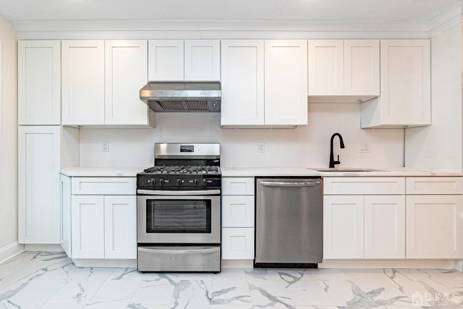 20 Warwick Road Edison, NJ 08820 - Photo 12 of 34 a kitchen with stainless steel appliances granite countertop a stove a white cabinet and a refrigerator
