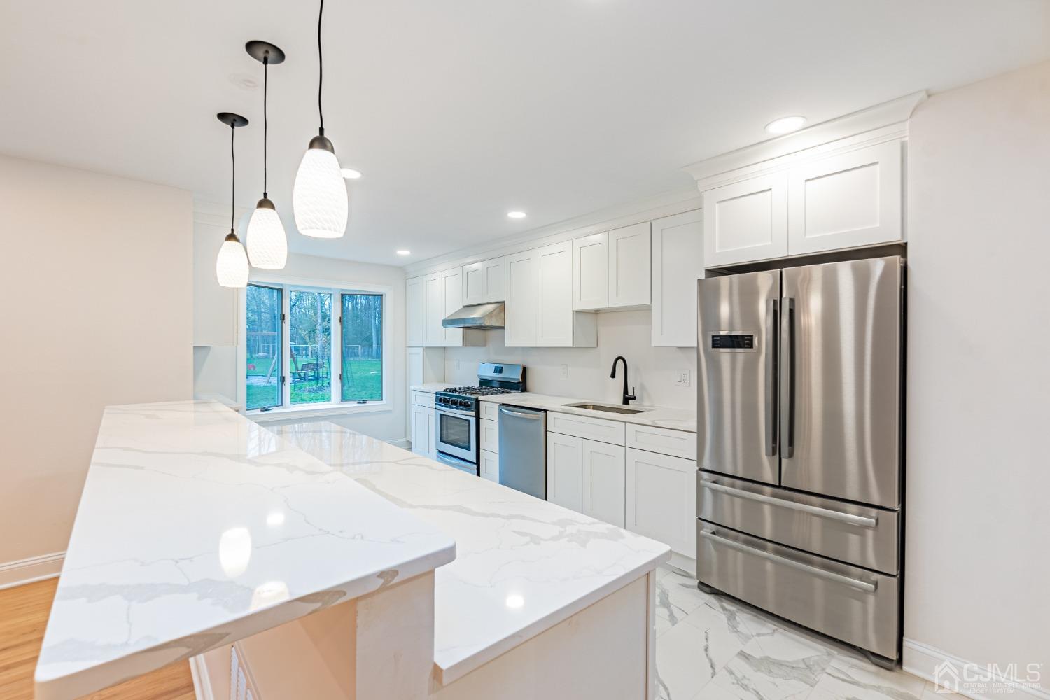 20 Warwick Road Edison, NJ 08820 - Photo 14 of 34 a kitchen with stainless steel appliances a refrigerator sink and microwave