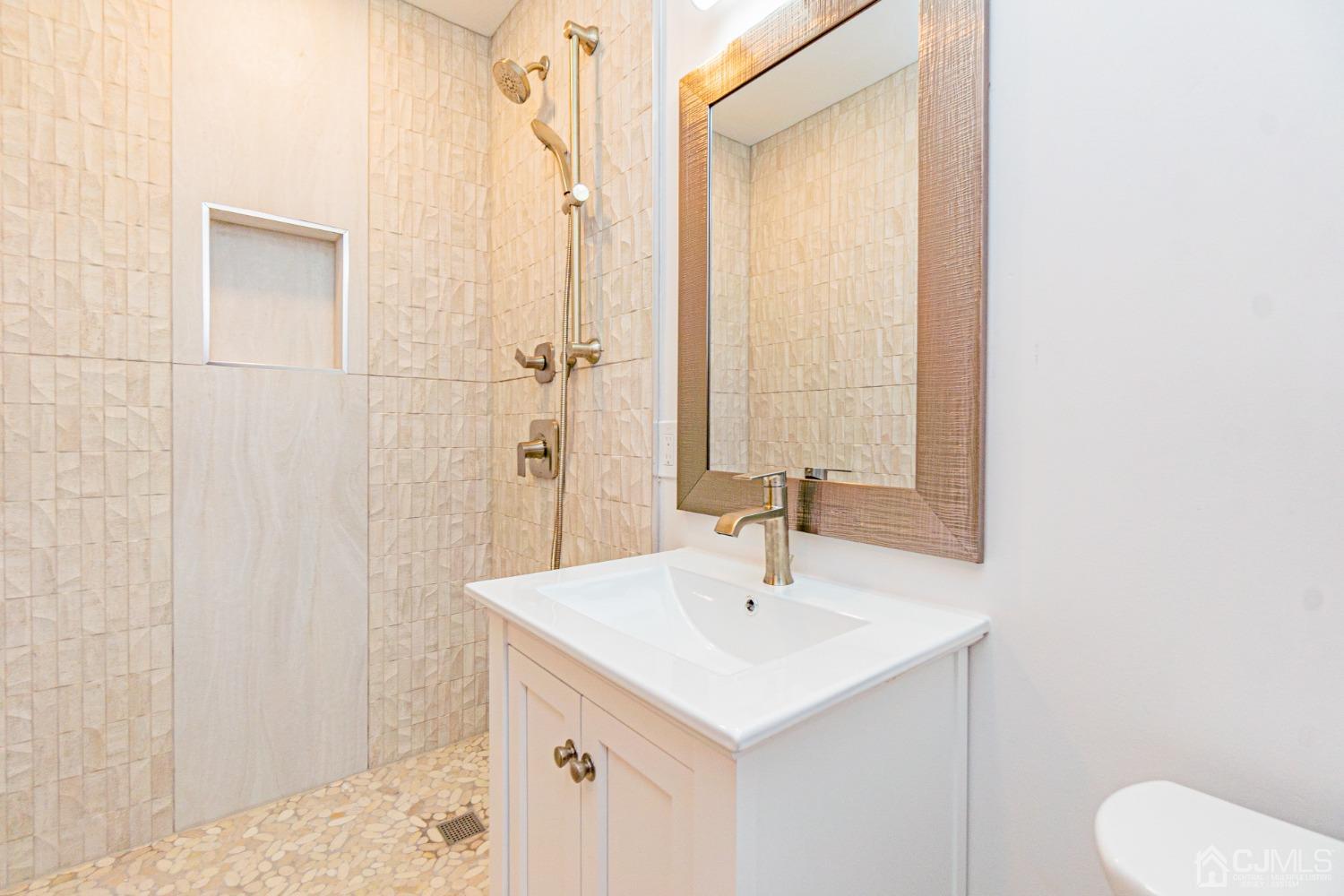 20 Warwick Road Edison, NJ 08820 - Photo 20 of 34 a bathroom with a sink a toilet and shower
