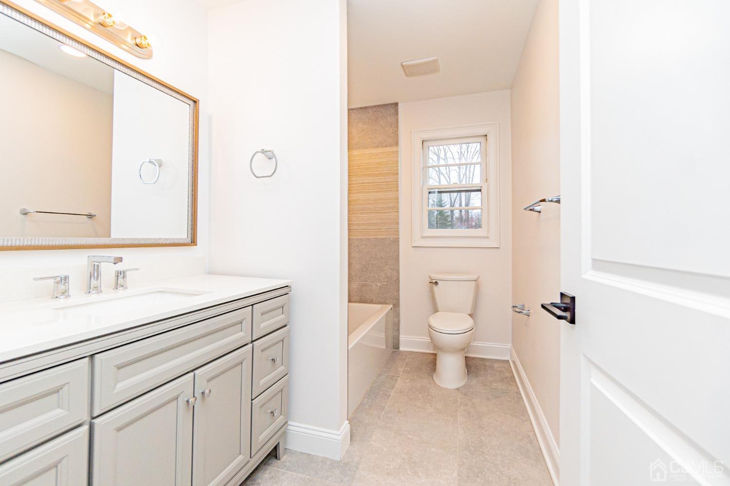 20 Warwick Road Edison, NJ 08820 - Photo 25 of 34 a bathroom with a toilet a sink and a mirror