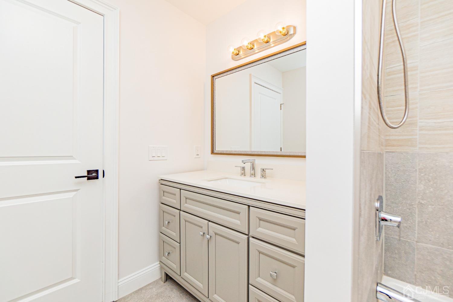 20 Warwick Road Edison, NJ 08820 - Photo 26 of 34 a bathroom with a granite countertop sink and a mirror