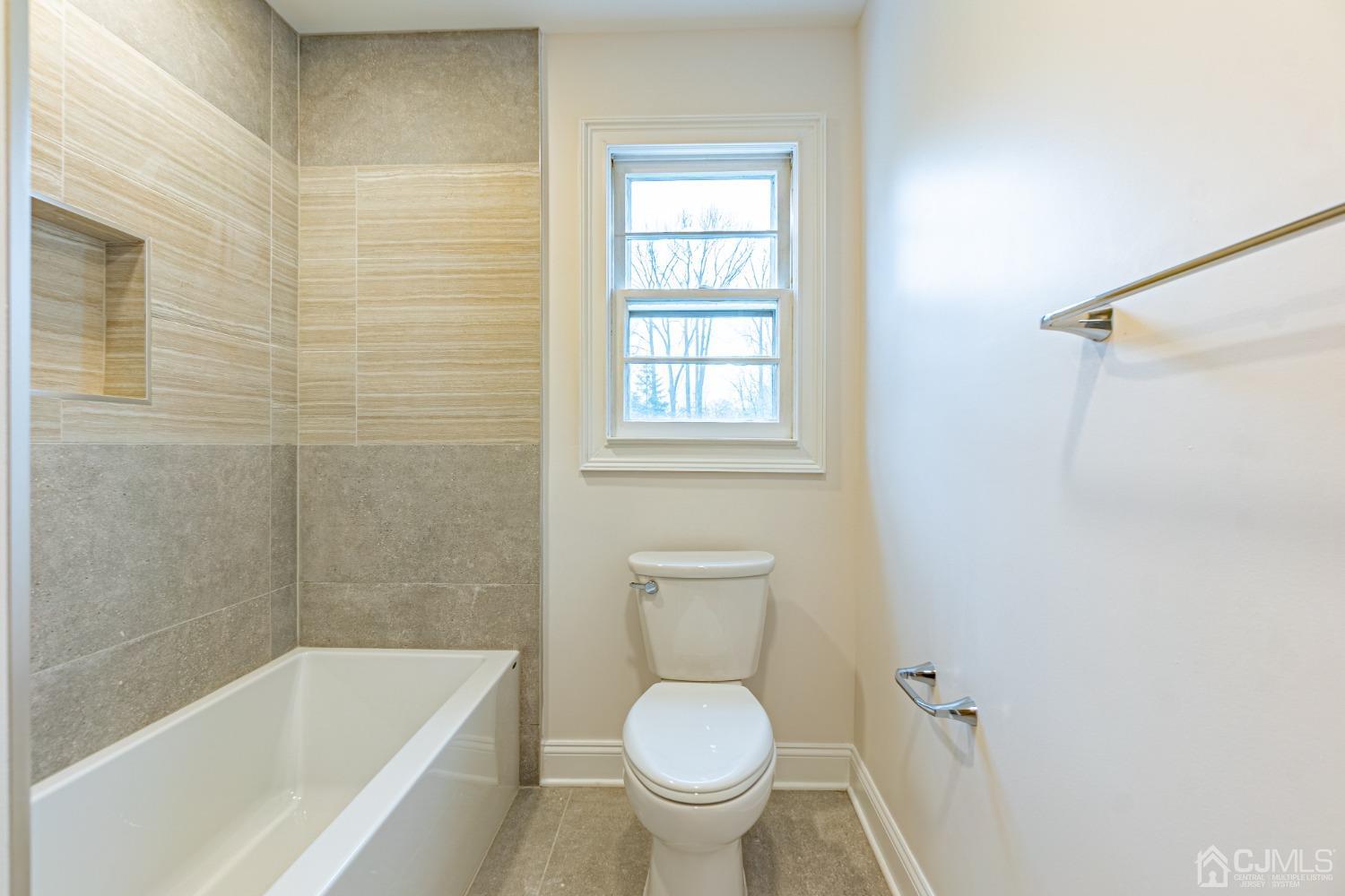 20 Warwick Road Edison, NJ 08820 - Photo 27 of 34 a white toilet sitting next to a bath tub