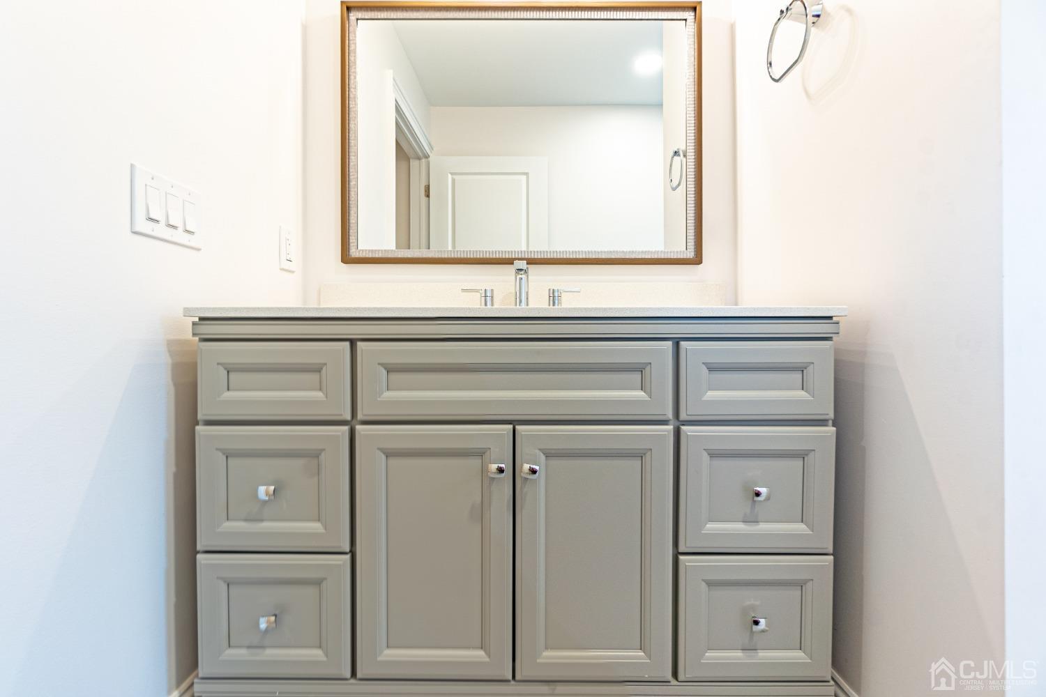 20 Warwick Road Edison, NJ 08820 - Photo 28 of 34 a bathroom with a sink a vanity and a mirror