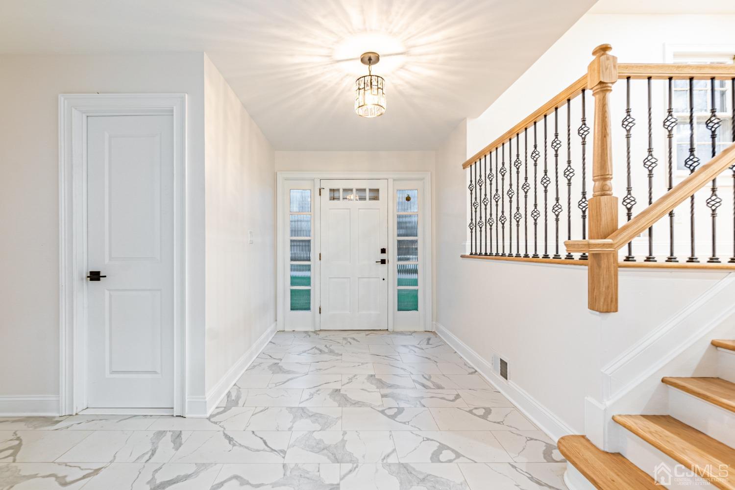 20 Warwick Road Edison, NJ 08820 - Photo 5 of 34 a view of a hallway with windows and chandelier cabinetry
