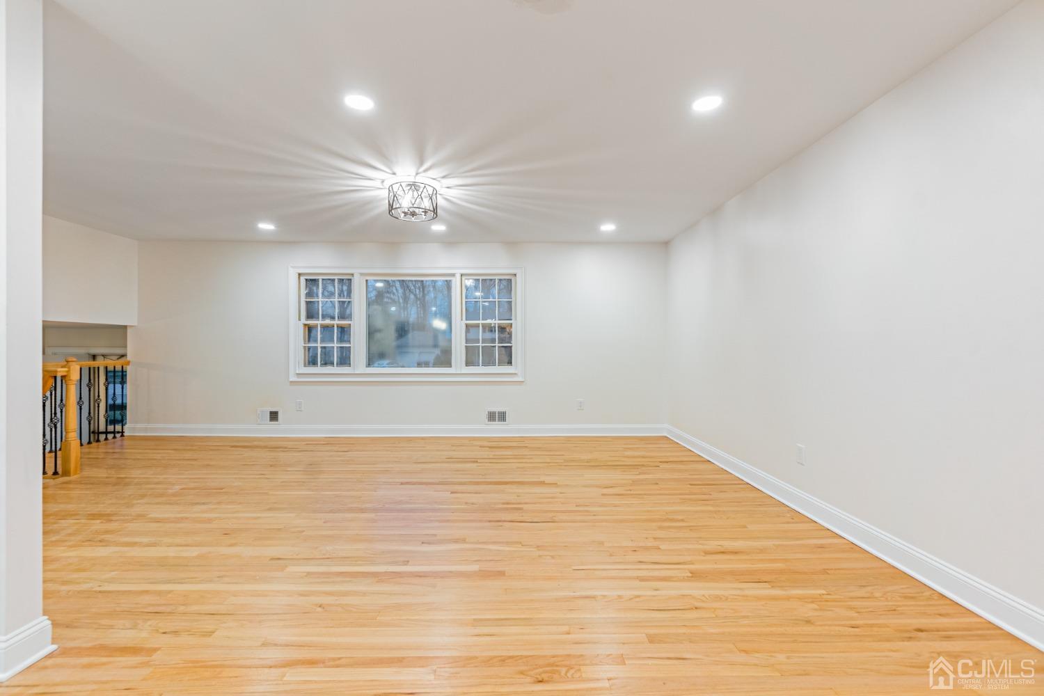 20 Warwick Road Edison, NJ 08820 - Photo 8 of 34 a view of an empty room with window and wooden floor