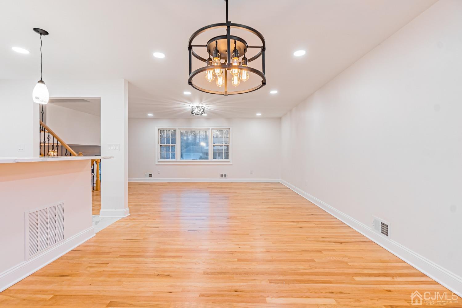 20 Warwick Road Edison, NJ 08820 - Photo 9 of 34 an empty room with wooden floor and windows