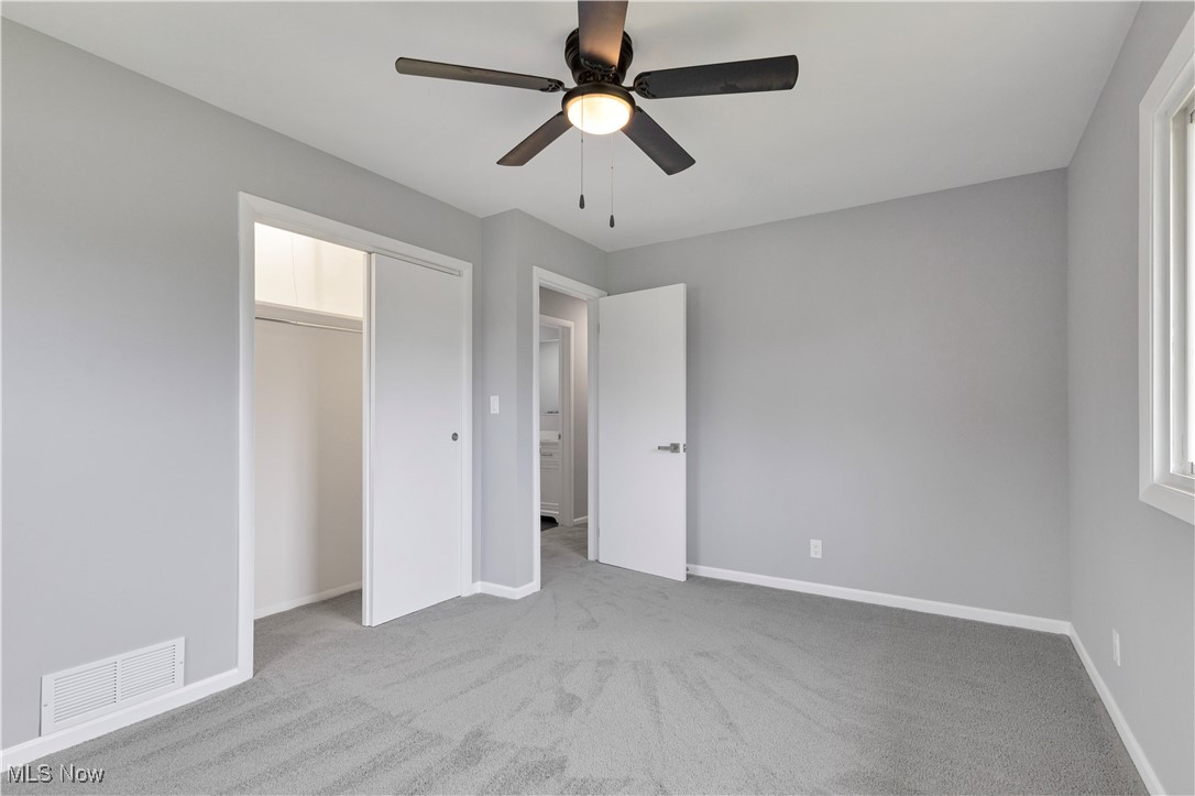 3071 Call Road Stow, OH 44224 - Photo 12 of 25 Unfurnished bedroom featuring a closet, ceiling fan, and light colored carpet