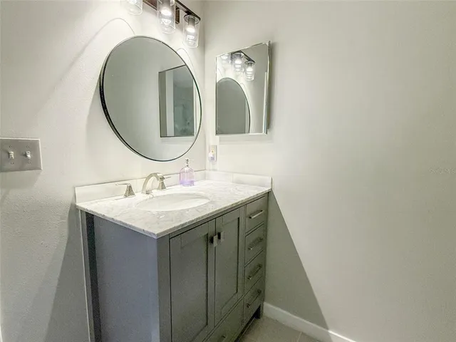 a bathroom with a sink and a mirror