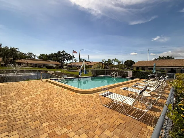 a view of a swimming pool with a lake view and houses in the back