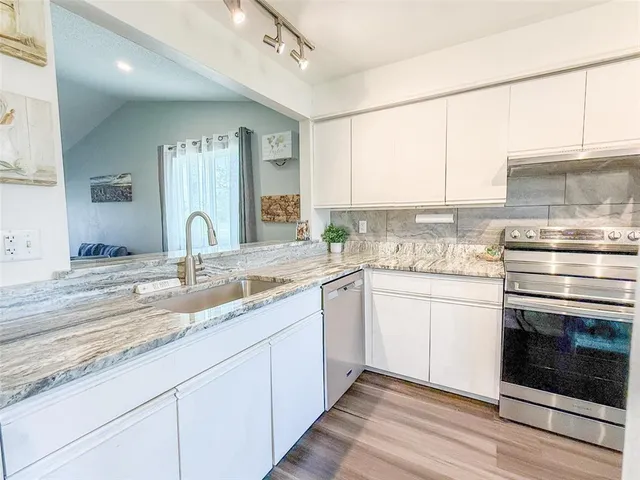 a kitchen with a sink stove and cabinets