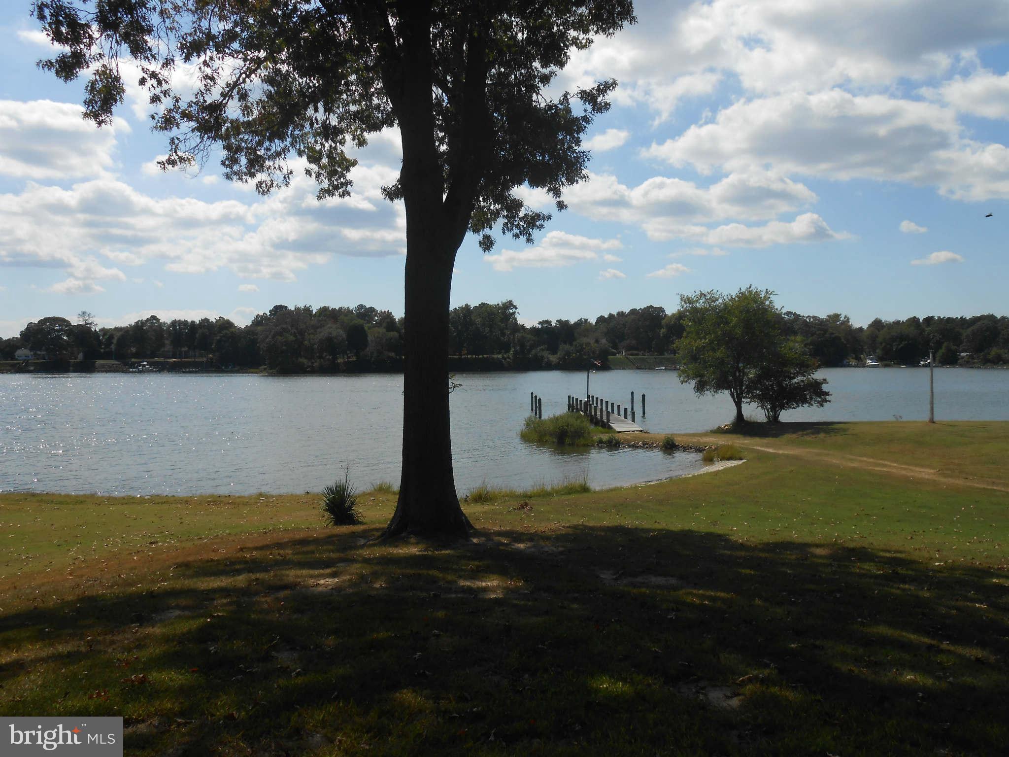 24244 Half Pone Point Road Hollywood, MD 20636 - Photo 12 of 19 a view of a lake with houses in background