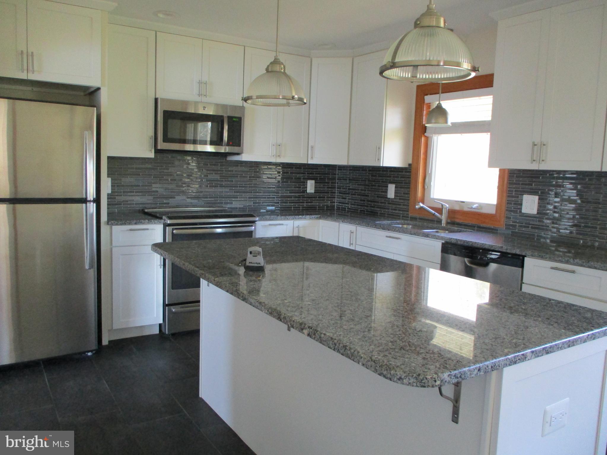 24244 Half Pone Point Road Hollywood, MD 20636 - Photo 2 of 19 a kitchen with stainless steel appliances granite countertop a sink a stove and a granite counter top