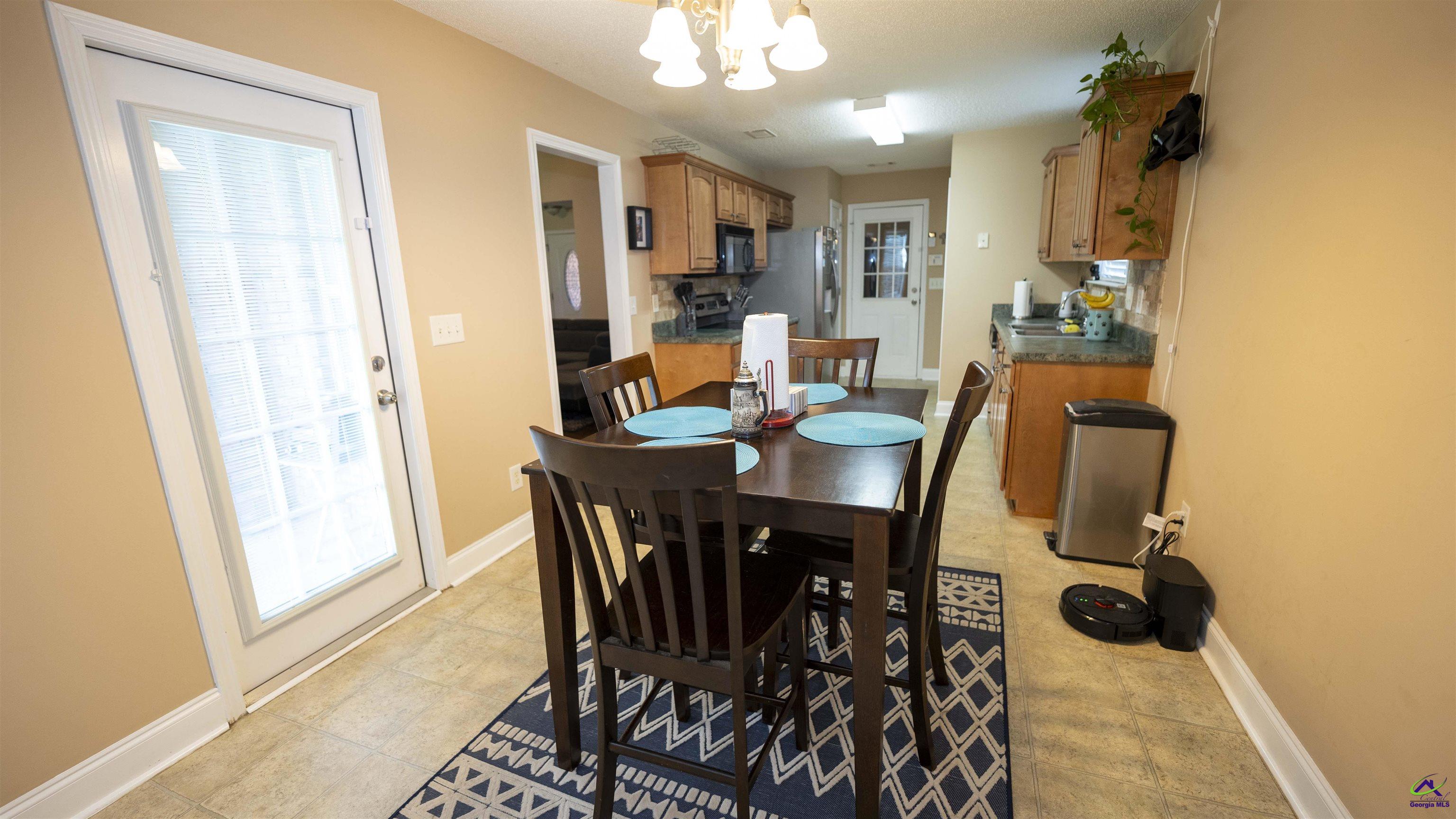 311 Sugarloaf Parkway Perry, GA 31069 - Photo 12 of 31 a view of a dining room with furniture and a chandelier