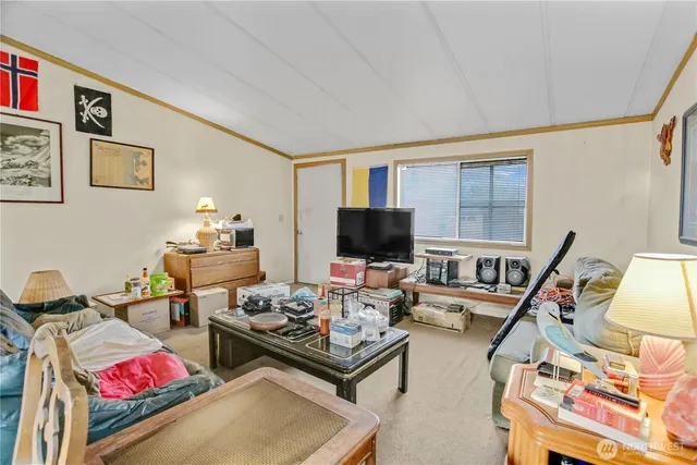 a living room with furniture a flat screen tv and a window