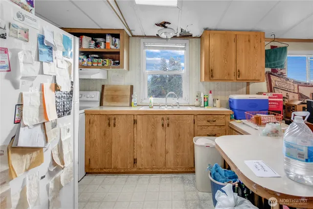 a room with furniture a rug and white walls