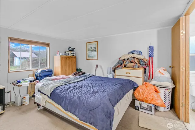 a bedroom with bed and a window