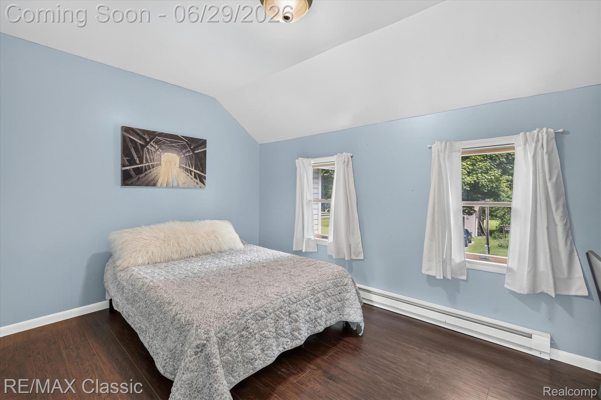 352 Meribah Road Highland, MI 48356 - Photo 18 of 39 Room featuring dark wood-finish flooring, light blue wall paint, and white trim