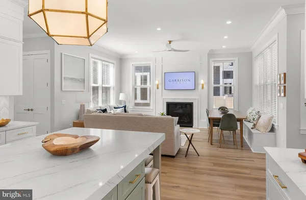 a kitchen with stainless steel appliances granite countertop a sink a stove and a wooden floors