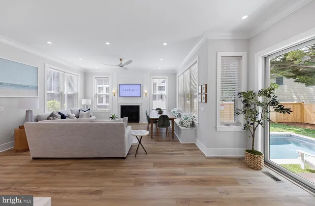 a living room with furniture a fireplace and a large window