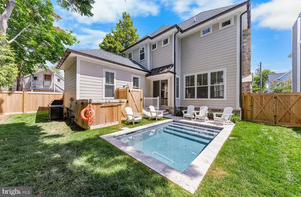 a view of a house with backyard sitting area and garden