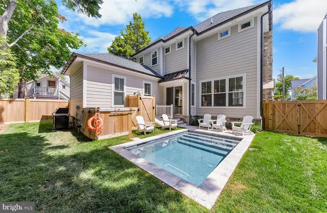 a view of a house with backyard sitting area and garden