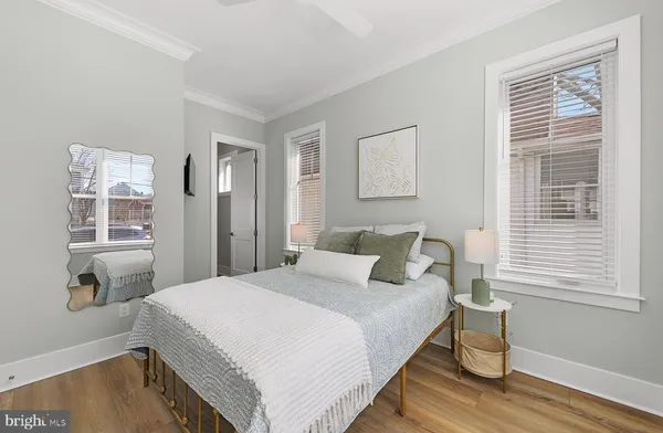 a bedroom with a bed and painting on the wall