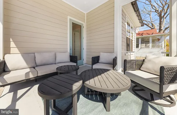 a bathroom with a granite countertop sink a toilet a mirror and next to a window