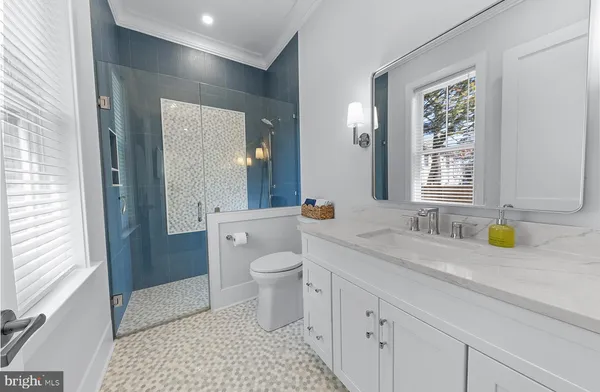 a bedroom with wooden floor and closet