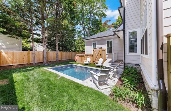 a view of house with backyard and a slide