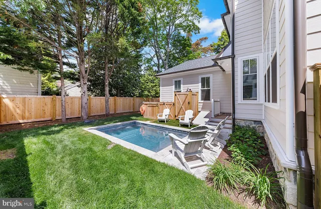 a view of house with backyard and a slide