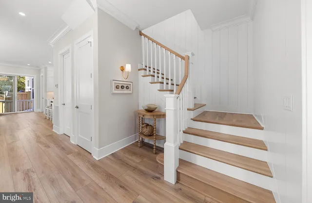 a view of entryway and hall with wooden floor