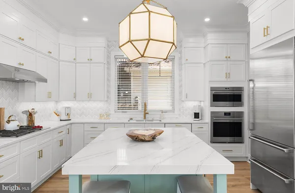 a kitchen with a sink a stove a refrigerator and cabinets