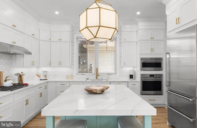 a kitchen with a sink a stove a refrigerator and cabinets