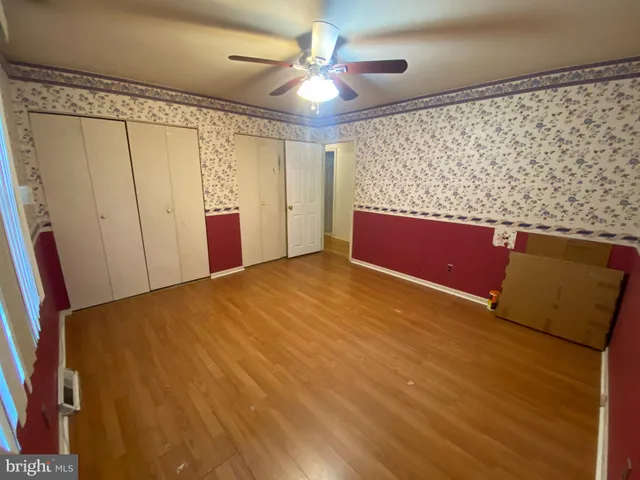a view of an empty room with a ceiling fan